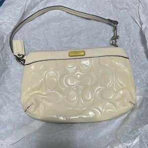 Coach cream color patent leather wristlet